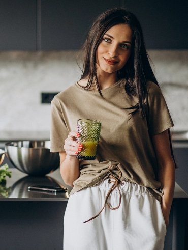 young-woman-drinking-juice-home